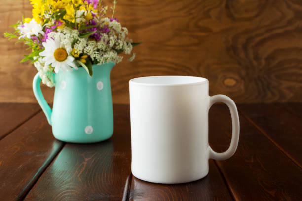 istock White coffee mug rustic mockup with wildflowers in mint green vase 948452032