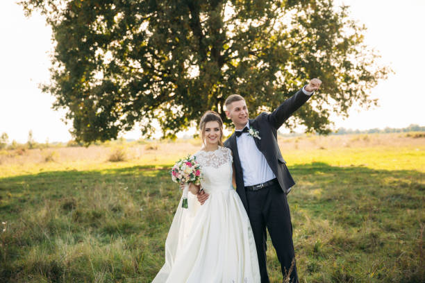 istock Funny couple in background of big tree 948452242