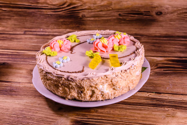 istock Kiev cake with cream on wooden table 948452362