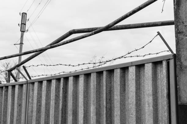 istock Barbed wire against the sky on cloudy day 948454844