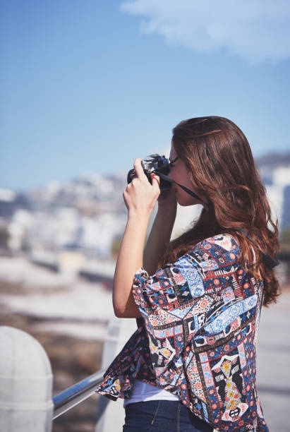 istock Beautiful brunette photographer taking stills on promenade 948455550