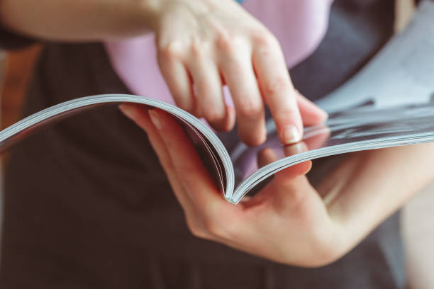 istock woman reading magazine at home 948459816