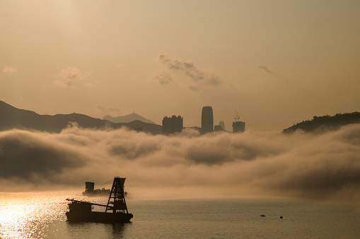 View of Island East, Hong Kong, at sunset on a foggy day