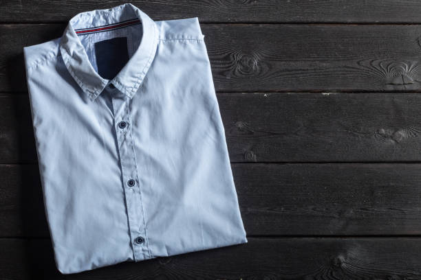 istock Blue shirt on a black wooden background 948464870