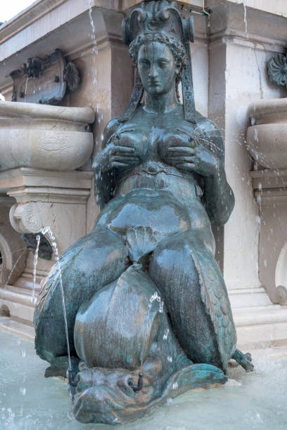 monument of the Neptune fountain a nereide (sea nymph) at the base of the monument of the Neptune fountain in Bologna (Italy) fountain photos stock pictures, royalty-free photos & images