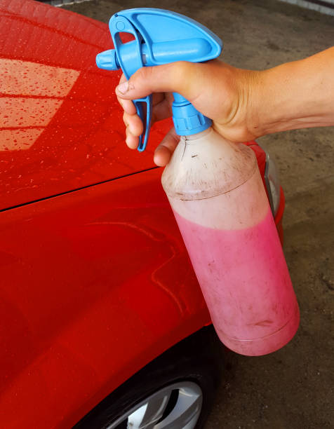 istock The man splashes the car with wax 948468884