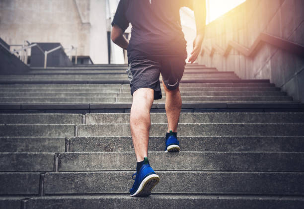 Success Close up of young man running up the stairs with running clothes stepping stock pictures, royalty-free photos & images