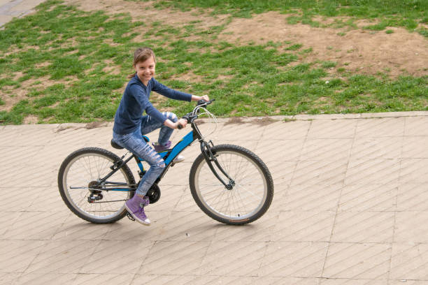 istock Girl rides a bike 948472202