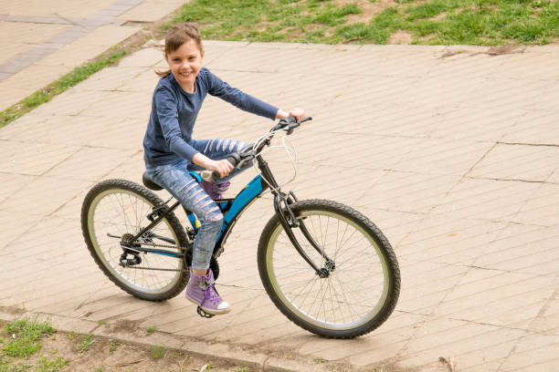 istock Girl rides a bike 948472788