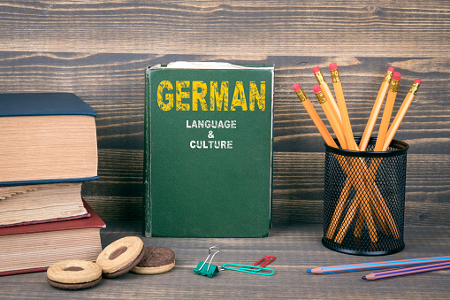 German language and culture concept. Book on a wooden background