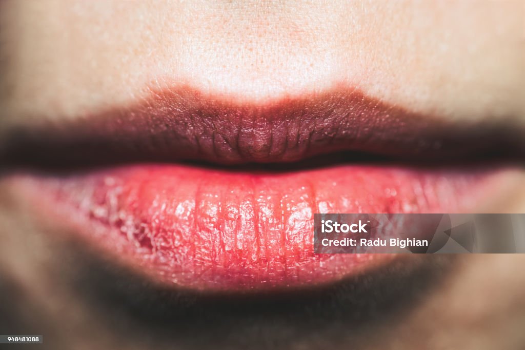 Close-Up Of Sensual Red Lips With Desire A close-up shot of sensual red lips with desire. Dry Stock Photo