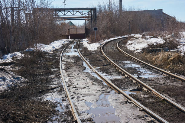 istock The old railway goes to an abandoned factory. 948481142