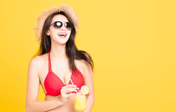 istock Happy woman wearing bikini and drinking  tropical cocktail 948490788