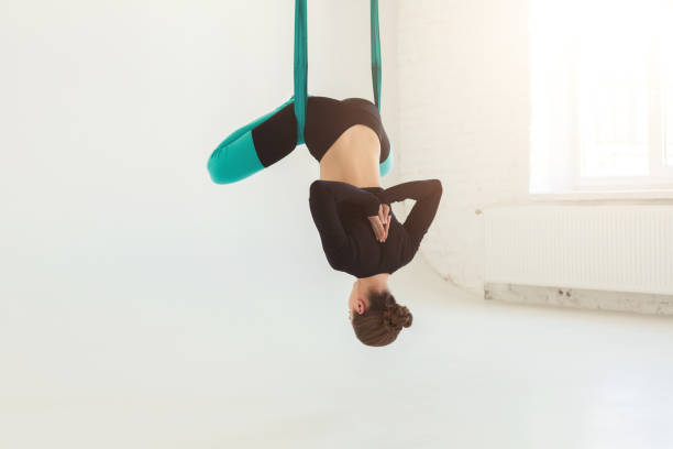 istock Woman practicing fly yoga over white background 948491660