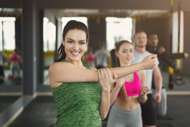 istock Young woman warming up before training in gym 948492170