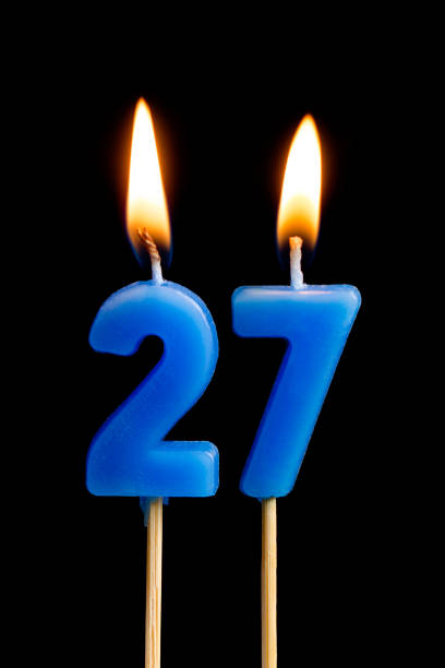 Burning candles in the form of 27 twenty seven (numbers, dates) for cake isolated on black background. The concept of celebrating a birthday, anniversary, important date, holiday, table setting Burning candles in the form of 27 twenty seven (numbers, dates) for cake isolated on black background. The concept of celebrating a birthday, anniversary, important date, holiday, table setting number 27 stock pictures, royalty-free photos & images