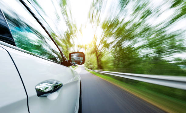 istock Car driving on the road in green forest 948492394