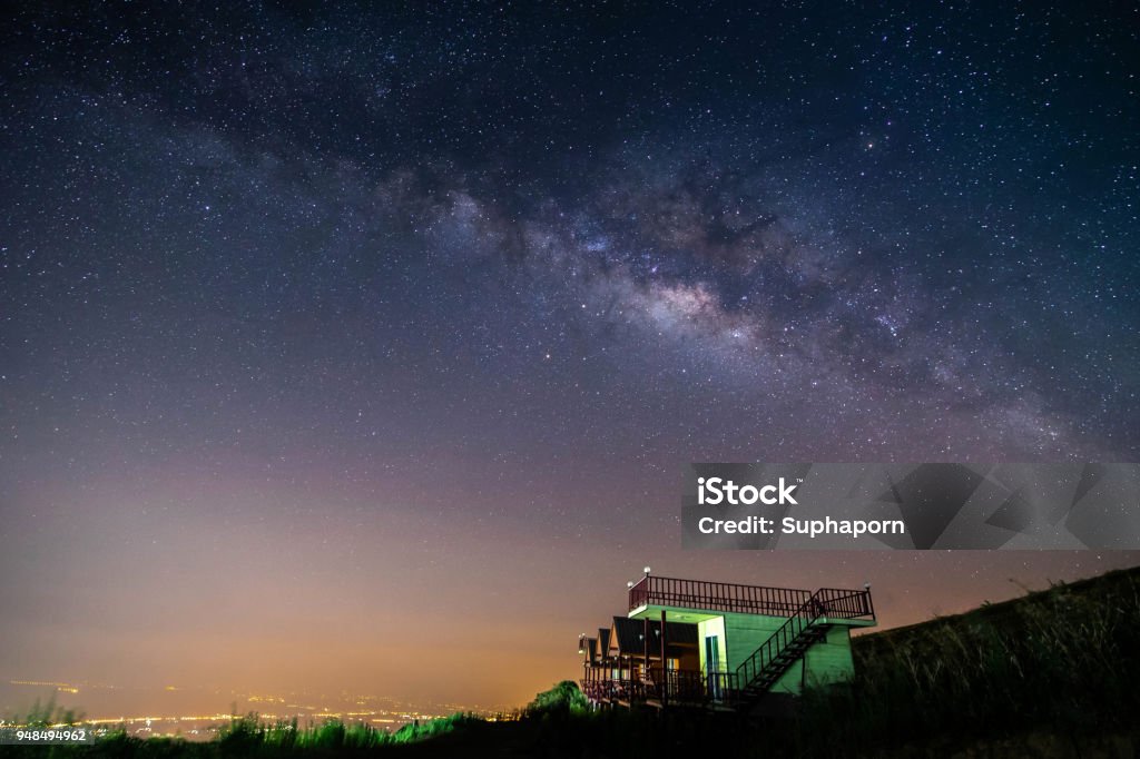 night landscape mountain and green hut milky way  galaxy background , thailand , long exposure , low light Astronomy Stock Photo