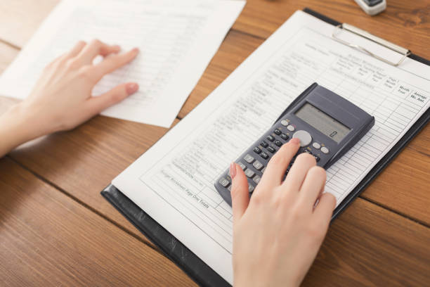 istock Closeup of woman hands counting on calculator 948495014