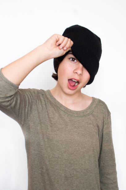 istock girl covering her middle face with a hat 948495142