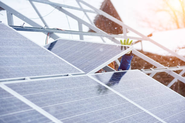 istock Process of installing solar panels in snowy weather at winter 948498126