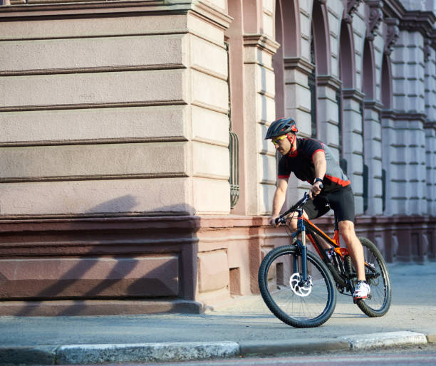 istock Cyclist passing historical buildings on bike 948498250