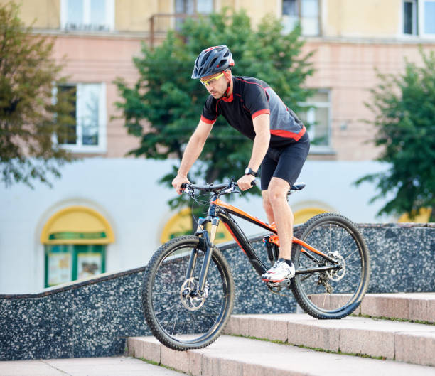 istock Male cyclist going down concrete stairs 948498460