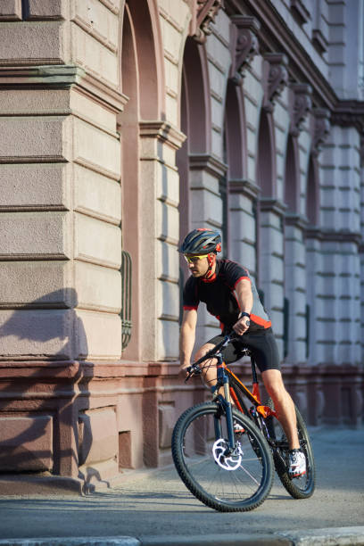 istock Cyclist passing historical buildings on bike 948498564