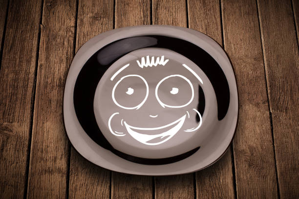 Happy smiley cartoon face on colorful dish plate and grungy background