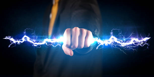 business man holding electricity light bolt in his hands - hands only flash imagens e fotografias de stock