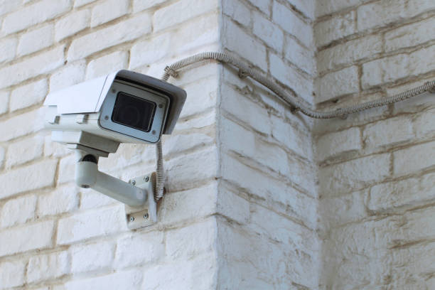 istock White video surveillance camera on the white wall 948499210