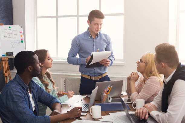 istock Man giving presentation to colleagues in office 948502820