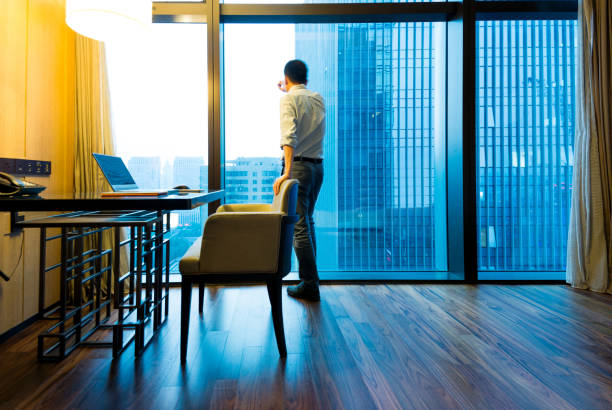 istock Businessman standing and looking out the window 948510678