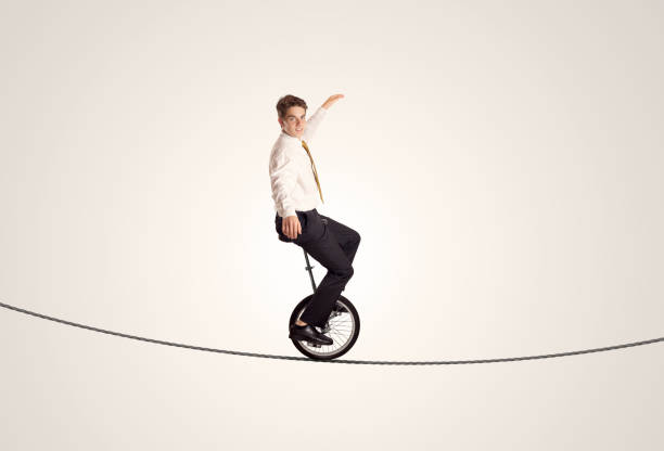 istock Extreme business man riding unicycle on a rope 948510836