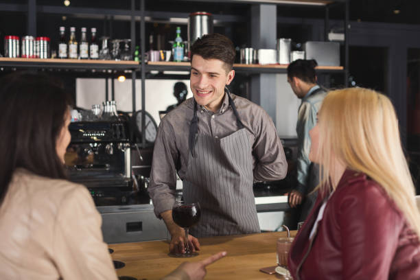 istock Smiling barista giving coffee to customer 948511190