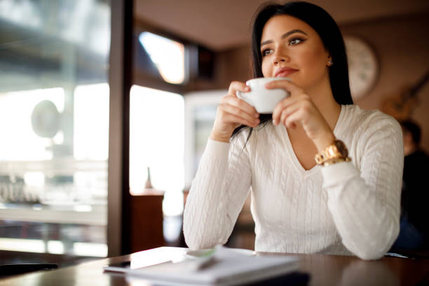 istock Woman drinking coffee in a cafe 948511202