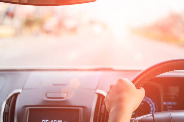 istock Soft focus driver hand holding steering wheel while driving on the road. 948511580