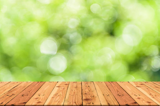 istock Wooden table on and blur nature tree green background for spring or summer concept. 948511650