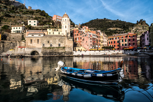 Tied boat in the bay of beautiful Vernazza town in the province of La Spezia, Liguria in Cinque Terre region in Italy.