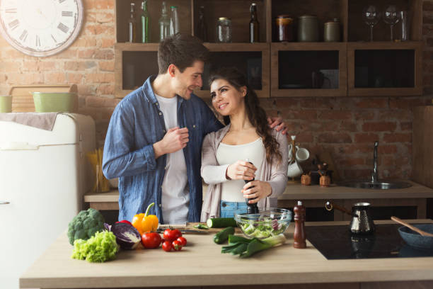 istock Happy couple cooking dinner together 948512112