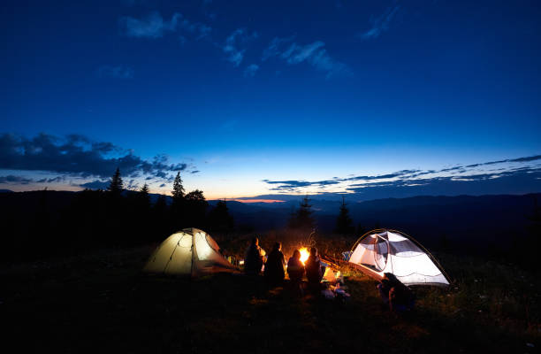 istock Family hikers having a rest at night camping in mountains 948512252