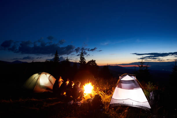 istock Family hikers having a rest at night camping in mountains 948512264