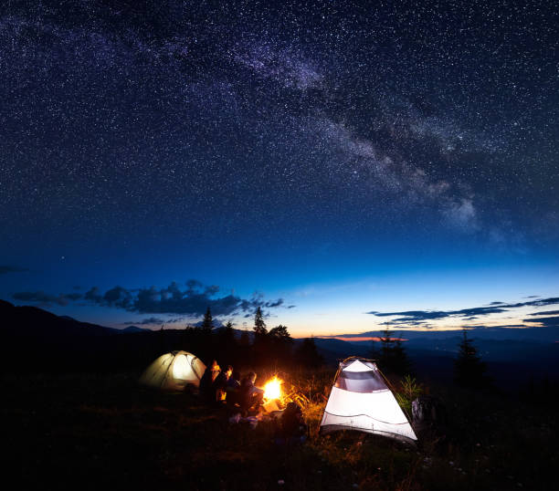 istock Family hikers having a rest at night camping in mountains 948512266