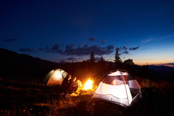 istock Family hikers having a rest at night camping in mountains 948512304