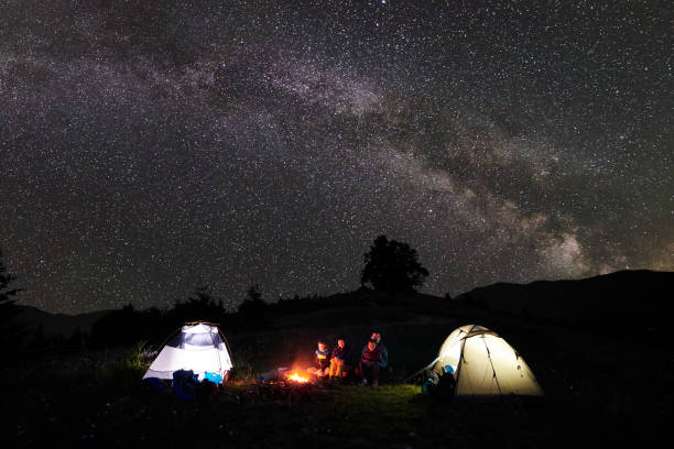 istock Family hikers having a rest at night camping in mountains 948512368