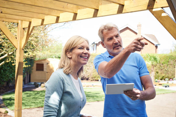istock Mature Woman Discussing Plan With Landscape Gardener Using Digital Tablet 948512518