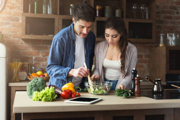 istock Happy couple cooking dinner together 948512558
