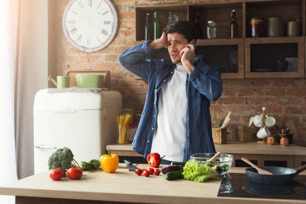 istock Disappointed man preparing healthy food in the home kitchen 948512984