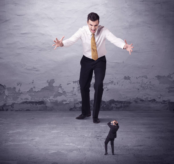 istock Angry big manager looking at small business man 948515668