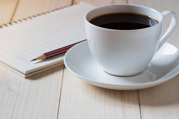 istock A cup of coffee and a notepad with pencil ontop 948516370